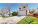 Charming two-story home with a spacious driveway, attached garage, stone accents, and a well-manicured lawn at 11836 Columbine St, Thornton, CO 80233