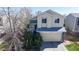 Charming two-story home featuring a two-car garage, a manicured lawn, and mature trees in a quiet neighborhood at 11836 Columbine St, Thornton, CO 80233