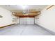 Clean, empty garage space with overhead storage and shelving providing extra organizational options at 11836 Columbine St, Thornton, CO 80233