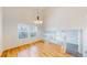 Sunlit living room featuring hardwood floors, large windows and an open layout at 11836 Columbine St, Thornton, CO 80233