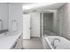 Contemporary bathroom featuring a glass-enclosed shower, soaking tub, double sink vanity, and modern finishes at 55 W 12Th Ave # 211, Denver, CO 80204