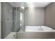 Modern bathroom featuring a luxurious soaking tub, glass-enclosed shower, and stylish tile work at 55 W 12Th Ave # 211, Denver, CO 80204