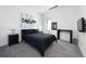 This stylish bedroom features a modern design, carpeted floors, a black bed and contemporary artwork at 55 W 12Th Ave # 211, Denver, CO 80204