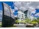 Modern building with unique architectural design and green landscaping at 55 W 12Th Ave # 211, Denver, CO 80204
