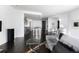 Open-concept living space with modern kitchen, dining area, dark floors, and comfortable seating at 55 W 12Th Ave # 211, Denver, CO 80204