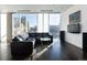 Modern living room with large windows, city views, comfortable seating, and sleek design at 55 W 12Th Ave # 211, Denver, CO 80204