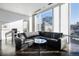 Bright living room with floor-to-ceiling windows, city views, and modern furnishings at 55 W 12Th Ave # 211, Denver, CO 80204
