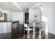 Open concept living space with modern island seating, dining area, and sleek design at 55 W 12Th Ave # 211, Denver, CO 80204
