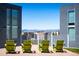 Relaxing outdoor patio featuring green Adirondack chairs and a view of the city and distant mountains at 55 W 12Th Ave # 211, Denver, CO 80204
