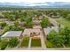 Aerial view of a home with a well-manicured lawn, driveway, and landscaped flowerbeds at 4891 Depew St, Denver, CO 80212