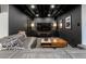 Finished basement with black ceiling, gray walls, and modern entertainment center at 4891 Depew St, Denver, CO 80212
