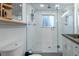 Bathroom showcasing a glass enclosed walk-in shower with white subway tiles, and dark countertops and fixtures at 4891 Depew St, Denver, CO 80212
