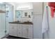 Bathroom featuring double vanity with stone countertop, white cabinets, a glass walk-in shower, and subway tile walls at 4891 Depew St, Denver, CO 80212