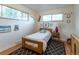 Cozy bedroom with hardwood floors, bright windows, and a fun decor, creating a cheerful atmosphere at 4891 Depew St, Denver, CO 80212