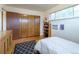 Comfortable bedroom with wood floors, large closet, and a window letting in natural light, creating a cozy space at 4891 Depew St, Denver, CO 80212