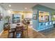 Dining room features hardwood floors and access to kitchen with breakfast bar at 4891 Depew St, Denver, CO 80212