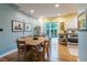Dining room with hardwood floors and access to backyard, adjacent to the kitchen at 4891 Depew St, Denver, CO 80212