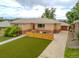 Charming home with a well-manicured lawn, walkway, landscaped flowerbeds, and mature trees at 4891 Depew St, Denver, CO 80212