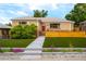 Charming brick home featuring a well-manicured lawn and inviting front entrance at 4891 Depew St, Denver, CO 80212