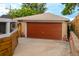 A single-car garage featuring a new door and additional space for storage at 4891 Depew St, Denver, CO 80212