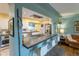 Modern kitchen with updated appliances, breakfast bar, and hardwood floors at 4891 Depew St, Denver, CO 80212