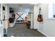Organized storage area with mounted skis, snowboards, and wall shelving at 4891 Depew St, Denver, CO 80212
