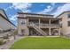 Spacious backyard featuring lush green grass and a multi-level deck, perfect for relaxing and entertaining outdoors at 8133 Arapahoe Peak St, Littleton, CO 80125