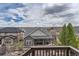 Backyard with wooden fence offers views of the neighborhood and cloudy skies at 8133 Arapahoe Peak St, Littleton, CO 80125