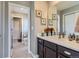 Bathroom featuring a dark wood vanity with a white countertop and an adjacent toilet room at 8133 Arapahoe Peak St, Littleton, CO 80125
