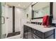 Sleek bathroom with a modern walk-in shower, custom vanity, and stylish black and white accents for spa-like experience at 8133 Arapahoe Peak St, Littleton, CO 80125