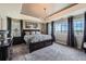 Spacious bedroom with tray ceilings, carpet floors, and abundant natural light at 8133 Arapahoe Peak St, Littleton, CO 80125