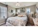 Neutral bedroom features a tufted headboard, multiple windows, and tasteful decor at 8133 Arapahoe Peak St, Littleton, CO 80125