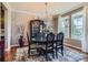 Traditional dining room with dark wood furnishings, chandelier, and a light-toned textured wall at 8133 Arapahoe Peak St, Littleton, CO 80125