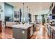 Open kitchen featuring a spacious island, stainless appliances, and seamless flow to the living area at 8133 Arapahoe Peak St, Littleton, CO 80125