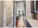 Hallway view into open kitchen featuring stainless appliances and hardwood floors at 8133 Arapahoe Peak St, Littleton, CO 80125