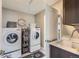 Functional laundry room with white appliances and ample counter space at 8133 Arapahoe Peak St, Littleton, CO 80125