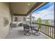 Comfortable covered patio features a seating area, dining table and scenic views at 8133 Arapahoe Peak St, Littleton, CO 80125