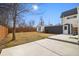 Large backyard with concrete patio, fence, and detached garage or workshop space at 1876 S Adams St, Denver, CO 80210