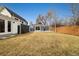 Spacious backyard featuring lush grass, a fenced perimeter, and a detached garage at 1876 S Adams St, Denver, CO 80210