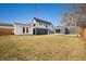 Expansive backyard with a detached garage, modern house, and well-maintained lawn at 1876 S Adams St, Denver, CO 80210
