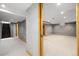 Spacious basement with neutral carpet, access to stairs, and multiple entry points at 1876 S Adams St, Denver, CO 80210