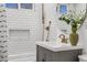 Close up of a bathroom featuring subway tiles, modern fixtures, shower, and stylish vanity at 1876 S Adams St, Denver, CO 80210
