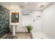 Bathroom featuring a pedestal sink with a floral wallpaper accent wall and a tiled walk-in shower at 1876 S Adams St, Denver, CO 80210