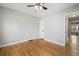 Empty bedroom with hardwood floors, neutral paint, ceiling fan, and a bright window at 1876 S Adams St, Denver, CO 80210