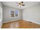 Empty bedroom with hardwood floors, neutral paint, ceiling fan, and a bright window at 1876 S Adams St, Denver, CO 80210