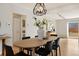 Dining room with modern light fixture, hardwood floors, and view to bedroom at 1876 S Adams St, Denver, CO 80210