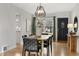 Dining room with modern light fixture, hardwood floors, and black accents at 1876 S Adams St, Denver, CO 80210