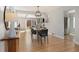 Dining room with view to living room featuring hardwood floors and stylish furnishings at 1876 S Adams St, Denver, CO 80210