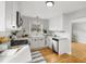 Bright kitchen features white cabinets, stainless steel appliances, subway tile backsplash, and hardwood floors at 1876 S Adams St, Denver, CO 80210