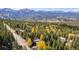 Aerial view of a home nestled in a tree-filled neighborhood near mountain ski slopes and scenic trails at 537 Moonstone Rd, Breckenridge, CO 80424